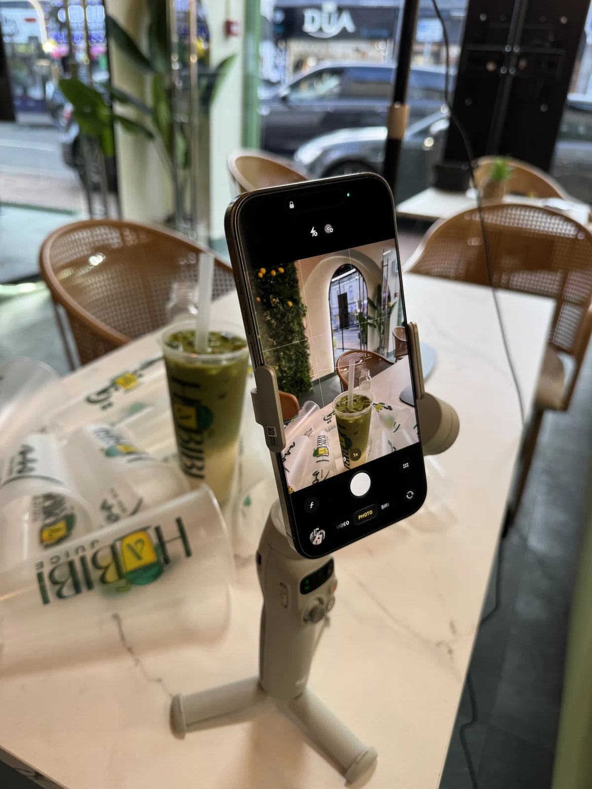 A phone on a gimbal filming a Habibi Juice drink inside the Birmingham store.